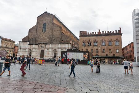 BOLOGNA, ITALY - JULY 10, 2019: People walk along Maggiore square with Basilica di San Petronio and Il Cinema Ritrovato Festival outdoor screen and seats in city historic center.のeditorial素材