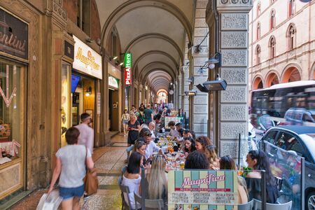 BOLOGNA, ITALY - JULY 10, 2019: People visit shopping Indipendenza street in city historic center. Bologna is the capital and largest city of the Emilia-Romagna region in Northern Italy.のeditorial素材