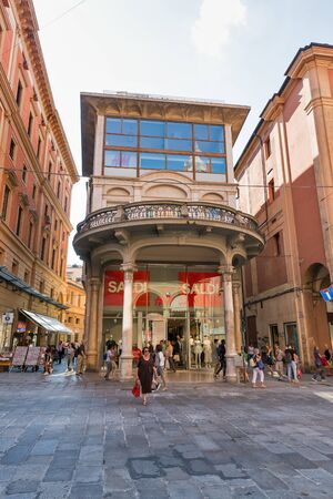 BOLOGNA, ITALY - JULY 10, 2019: People visit H&M store on shopping Indipendenza street in historic center. It is a Swedish multinational clothing-retail company known for its fast-fashion clothing.のeditorial素材