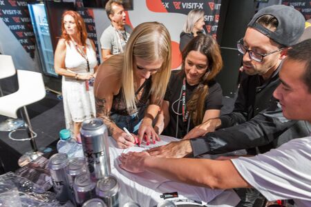 BERLIN, GERMANY - OCTOBER , 2019: Woman actress works at Visit-X online porno video live sex cams...