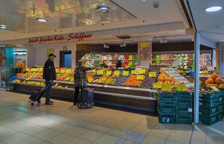 BERLIN, GERMANY - NOVEMBER 18, 2019: People visit Kube-Schiffner fruit and vegetables store in Markisches Trade Center. Berlin is the capital and largest city of Germany by both area and population.のeditorial素材