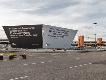 BERLIN, GERMANY - OCTOBER 18, 2019: Uber and Sixt advertisement in front of Tegel Otto Lilienthal airport. It is the main international airport of Berlin, the federal capital of Germany.のeditorial素材