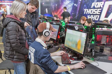 KYIV, UKRAINE - APRIL 06, 2019: People playing computer games at Republic of Gamers booth, a brand...