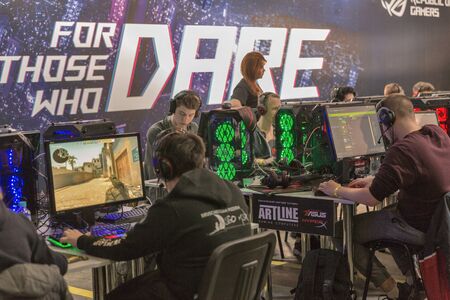 KYIV, UKRAINE - APRIL 06, 2019: People playing computer games at Republic of Gamers booth, a brand...