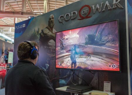 KYIV, UKRAINE - APRIL 06, 2019: Man playing Sony Play Station 4 at booth during CEE 2019, the...