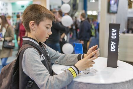 KYIV, UKRAINE - APRIL 06, 2019: A boy visit Samsung, a South Korean multinational conglomerate...