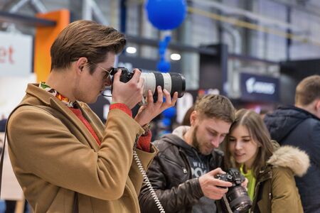 KYIV, UKRAINE - APRIL 13, 2019: People testing professional photographic cameras on Sony company...