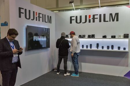KYIV, UKRAINE - APRIL 13, 2019: People testing professional photographic cameras on FujiFilm company...