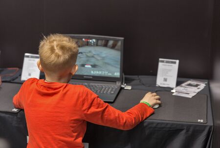KYIV, UKRAINE - APRIL 13, 2019: Little boy plays computer game at booth during CEE 2019, the largest consumer electronics trade show of Ukraine in Tetra Pack EC.のeditorial素材