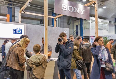 KYIV, UKRAINE - APRIL 13, 2019: People testing professional photographic cameras on Sony company...