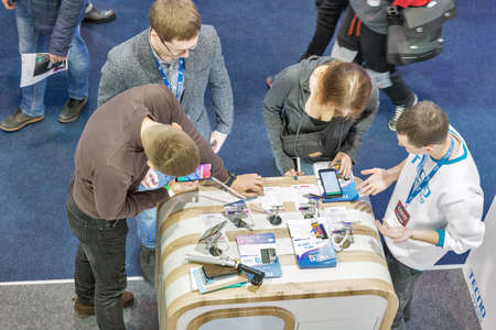 KYIV, UKRAINE - APRIL 13, 2019: People visit Tecno Mobile modern mobile phones company booth during...