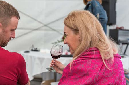 KYIV, UKRAINE - MAY 19, 2018: People tasting wine during Food and Wine Festival in National Expocenter, a permanent multi-purpose exhibition complex.のeditorial素材