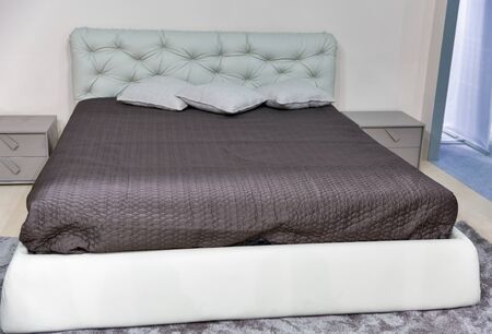 Empty modern elegant bedroom furniture interior in modern style with pillowsの写真素材