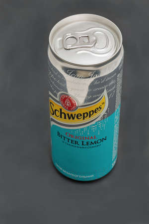 KYIV, UKRAINE - DECEMBER 31, 2019: Schweppes Bitter Lemon Original can closeup against black...