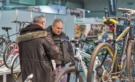 KYIV, UKRAINE - FEBRUARY 26, 2016: People visit bicycle trade manufacturer booth during International Bicycle Exhibition VELOBIKE 2016 in KyivExpoPlaza Exhibition Center.のeditorial素材