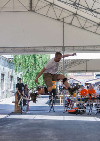 KIEV, UKRAINE - MAY 23, 2015: Sport competition with jumping stilts at International Tattoo Convention Kyiv Tattoo Collection 2015 organized by Planeta Tattoo studio in Art-factory Platforma.のeditorial素材