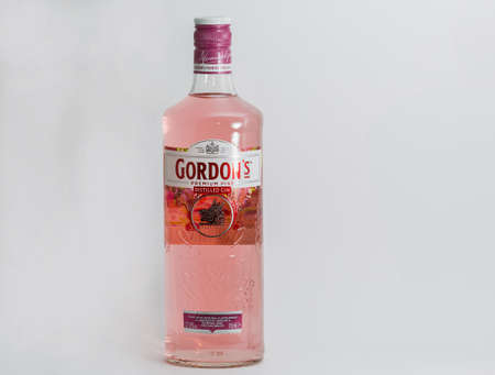 KYIV, UKRAINE - JUNE 17, 2020: Gordons premium pink gin bottle closeup against white background. Gin...