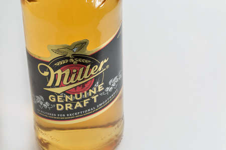 KYIV, UKRAINE - JUNE 17, 2020: Miller Genuine Draft lager beer bottle closeup against white background. Miller Brewing Company is an American beer company headquartered in Milwaukee, Wisconsin.のeditorial素材