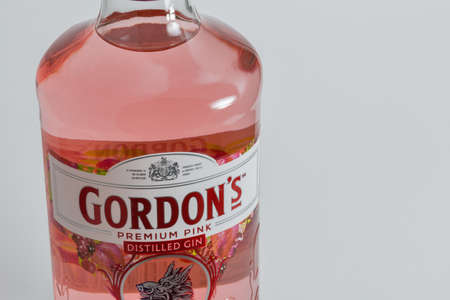 KYIV, UKRAINE - JUNE 17, 2020: Gordons premium pink gin bottle label closeup against white background. Gin is a distilled alcoholic drink that derives its predominant flavour from juniper berries.のeditorial素材