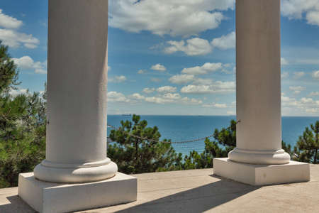 Colonnade in Chernomorsk city on a sunny summer day, Ukraine. Black Sea in the background.