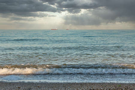 Black Sea seascape with dramatic clouds and cargo ships. Odessa, Ukraine.