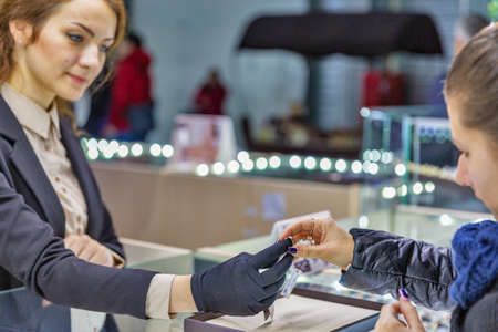 KYIV, UKRAINE - DECEMBER 18, 2015: People visit Jewellery Factory Zolotoy Vek or Golden Age booth during Christmas Jeweller Expo at KyivExpoPlaza Exhibition Center.のeditorial素材