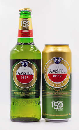 KYIV, UKRAINE - SEPTEMBER 14, 2020: Amstel beer can and bottle closeup against white background. Amstel is a Dutch brewery founded 1870 in Amsterdam. It was taken over by Heineken in 1968.のeditorial素材