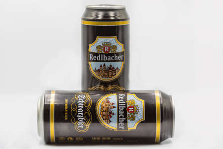 KYIV, UKRAINE - SEPTEMBER 14, 2020: German Redlbacher Bavarian Schwarzbier dark lager beer cans closeup against white background.のeditorial素材