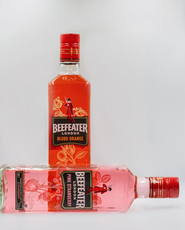 KYIV, UKRAINE - DECEMBER 16, 2020: Beefeater London Pink Strawberry and Blood Orange premium gin bottles closeup against white background. Gin is a distilled alcoholic drink from juniper berries.のeditorial素材