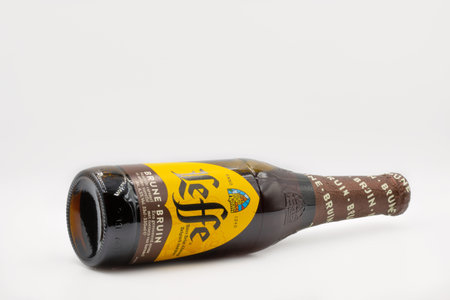 KYIV, UKRAINE - FEBRUARY 27, 2021: Studio shot of Belgian Leffe Brune dark beer bottle closeup against white background. Leffe is made by Abbaye de Leffe in Belgium.のeditorial素材