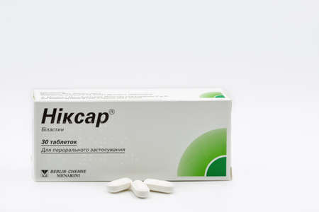 KYIV, UKRAINE - MARCH 06, 2021: Studio shot of Nixar bilastin in paper box package tablets by Berlin Chemie Menarini closeup against white. Bilastine 20 mg is a non-sedating antihistamine drug.のeditorial素材