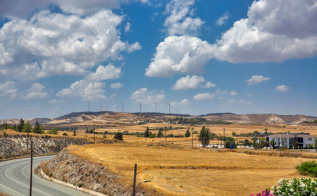 Typical Cypriot summer landscape wit highway, wind farms and residential house close to Larnaca, Cyprus.の写真素材