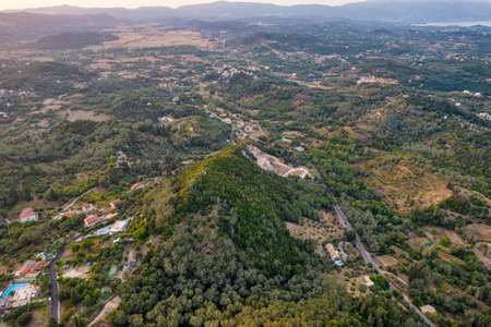 Aerial drone view over typical rural landscape in central Island of Corfu at sunset, Greece.の写真素材
