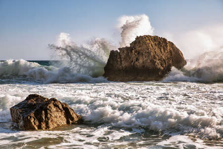 Beautiful scenic view sea waves crashing onto rocks with water splashes. Corfu island, Greece.の写真素材