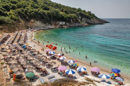 Saranda, Albania - July 29, 2021: People visit coastal Monastery Beach. Saranda is located on an open sea gulf of the Ionian Sea within the Mediterranean Sea.のeditorial素材