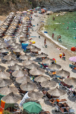 Saranda, Albania - July 29, 2021: People visit coastal Monastery Beach. Saranda is located on an open sea gulf of the Ionian Sea within the Mediterranean Sea.のeditorial素材