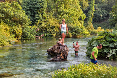 Muzine, Albania - July 29, 2021: People visit popular tourist attraction The Blue Eye water spring near Muzine in Vlore County, southern Albania.のeditorial素材