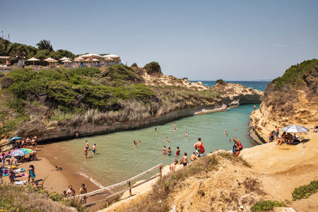 Sidari, Corfu, Greece - August 01, 2021: People swim and sunbath in famous Canal D'amour.のeditorial素材