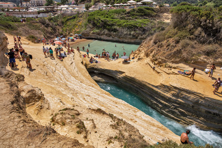 Sidari, Corfu, Greece - August 01, 2021: People swim and sunbath in famous Canal D'amour. Sidari is a settlement in the northern part of the island of Corfu.のeditorial素材