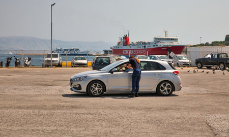 Kerkyra, Corfu, Greece - August 10, 2021: Car transport control before loading to ferry ship in...