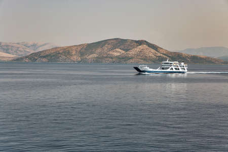 Seascape with the ferry ship sails in the distance off the coast of Greeceの写真素材