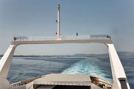 Seascape with the ferry ship sails in off the coast of Greece. Corfu island in the background.