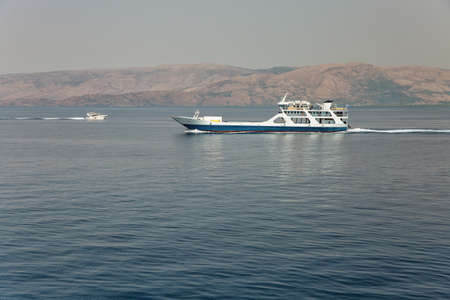 Seascape with the ferry ship sails in the distance off the coast of Greeceの写真素材