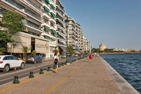 Thessaloniki, Greece - July 27, 2021: Cityscape with people walking along waterfront. It is the...