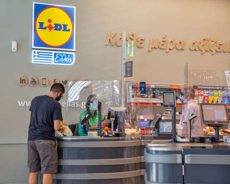 Corfu, Greece - August 03, 2021: People visit Lidl supermarket. Lidl is a German discount...