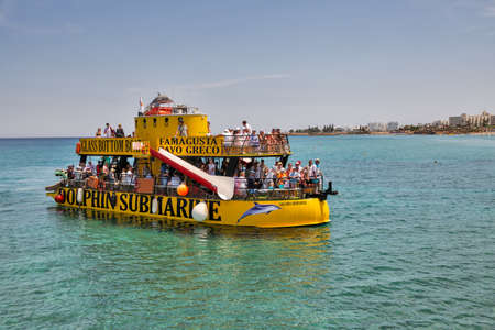 Protaras, Cyprus - May 25, 2021: People travel by Dolphine Submarine entertainment boat with glass...