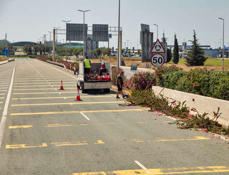 Larnaca, Cyprus - May 31, 2021: Bush pruning road works on highway to Larnaca airport. Larnaca is the third-largest city in the country, after Nicosia and Limassol.のeditorial素材