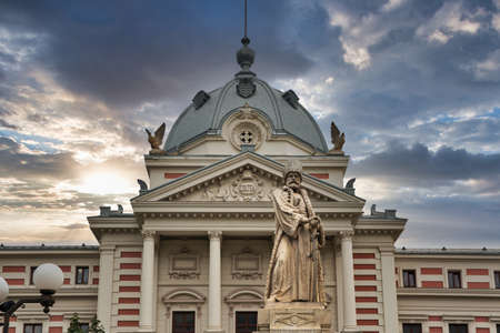Dramatic sky over the statue of Mihail Cantacuzino and Coltea Clinical Hospital in Bucharest, capital of Romania. Hospital was built in 1704, destroyed by an earthquake in 1802 and rebuilt in 1888.のeditorial素材