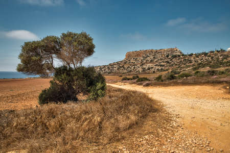 Landscape road to Cape Greco peninsula, Cyprus. It is mountainous peninsula with a national park, rock paths, a turquoise lagoon and a natural stone bridge.の写真素材