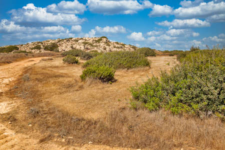 Rural landscape close to Ayia Napa, Cyprus. It is mountainous peninsula with a national park, rock paths, a turquoise lagoon and a natural stone bridge.の写真素材